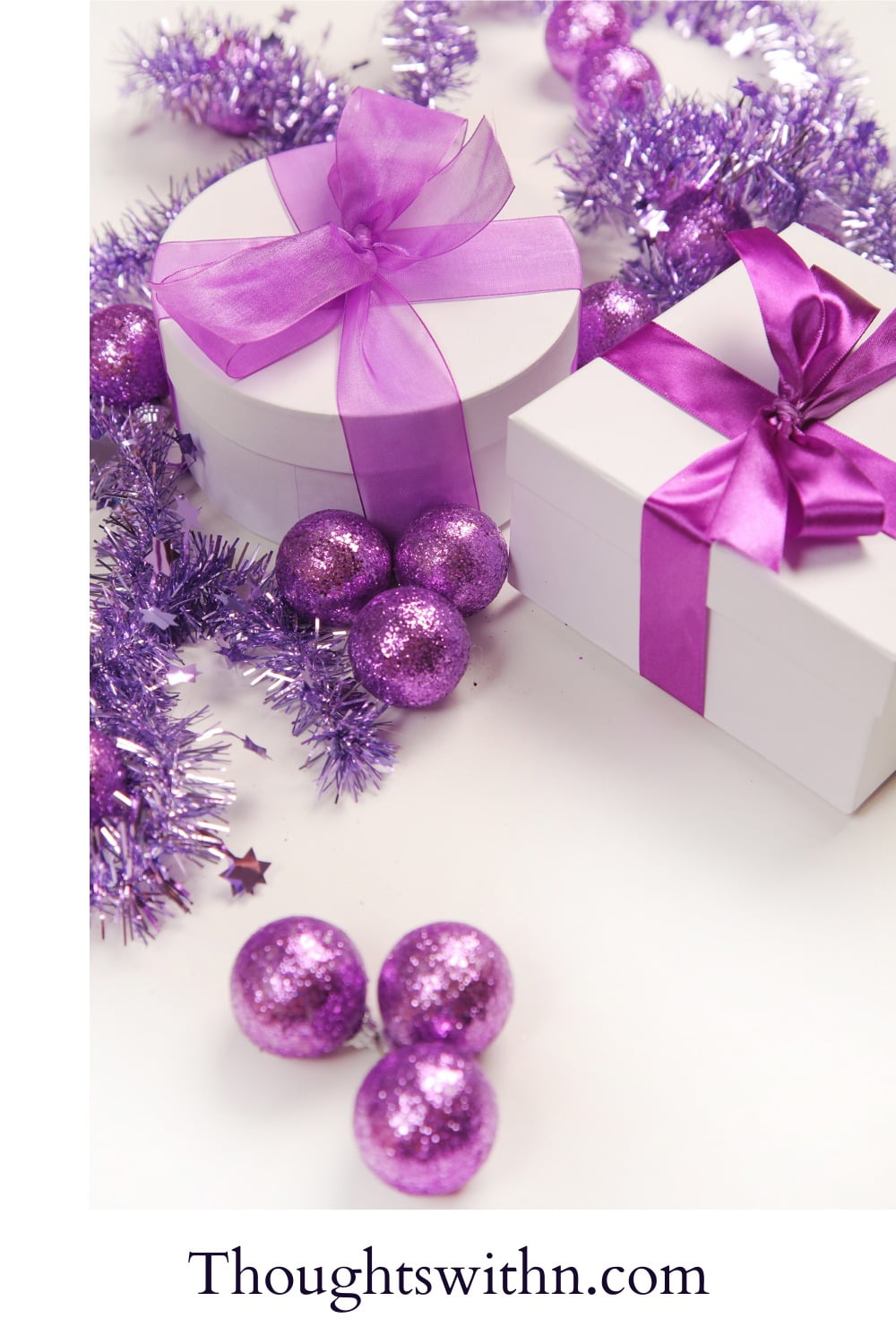 A white background with light purple ornamental balls and white presents with purple bow. Purple festive scene.